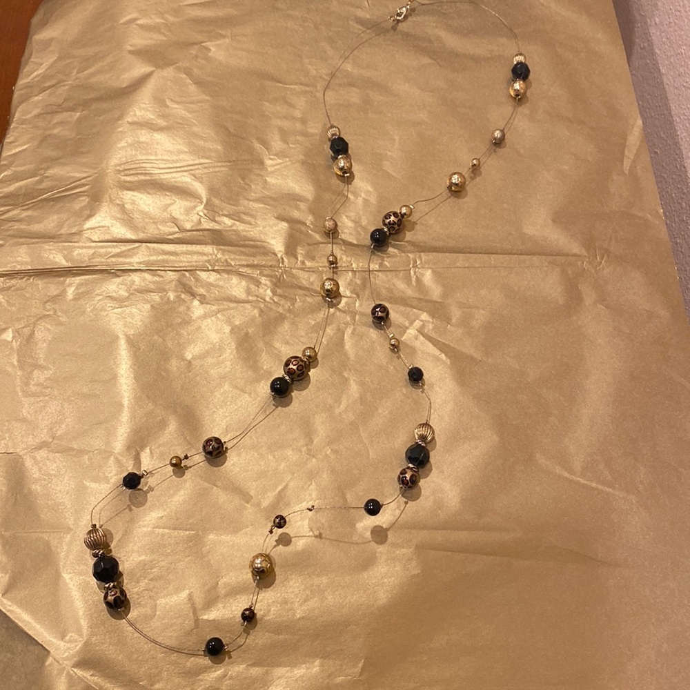 Necklace with black and gold tone beads